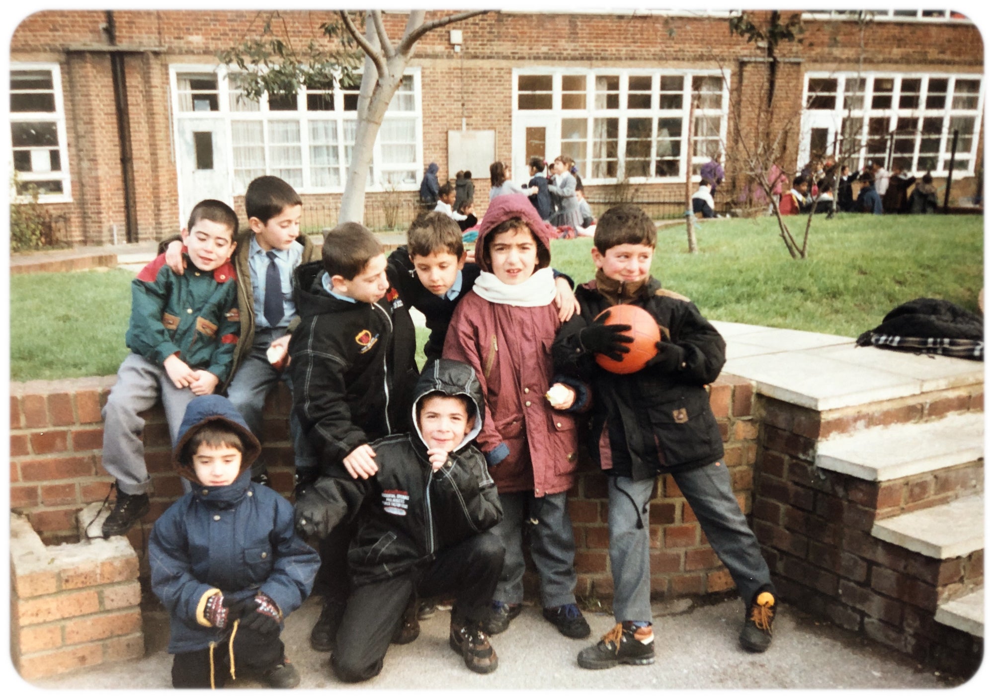 A young Cemal, right, shyly joins a group photo with Ali, center in red jacket in London. Photo provided to Rudaw by Ali Kalkan.